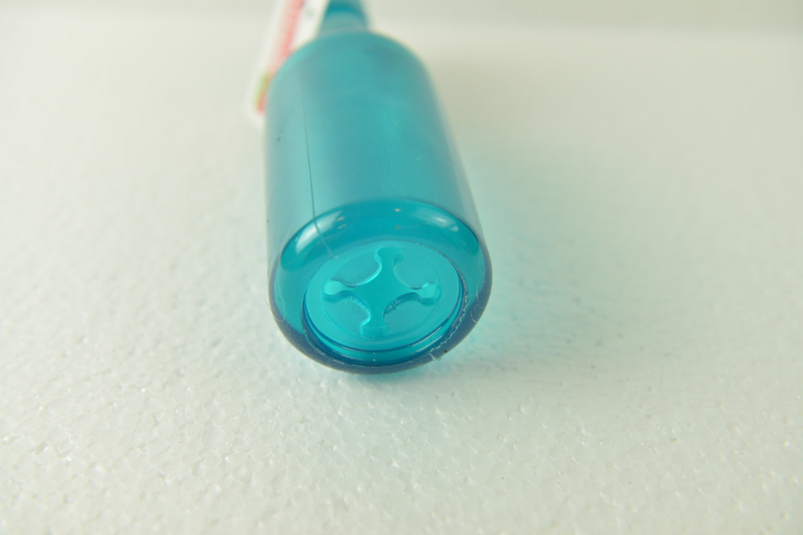 Close-up of a blue cylindrical object on a textured white surface at Pet Servo
