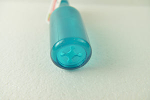 Close-up of a blue cylindrical object on a textured white surface at Pet Servo