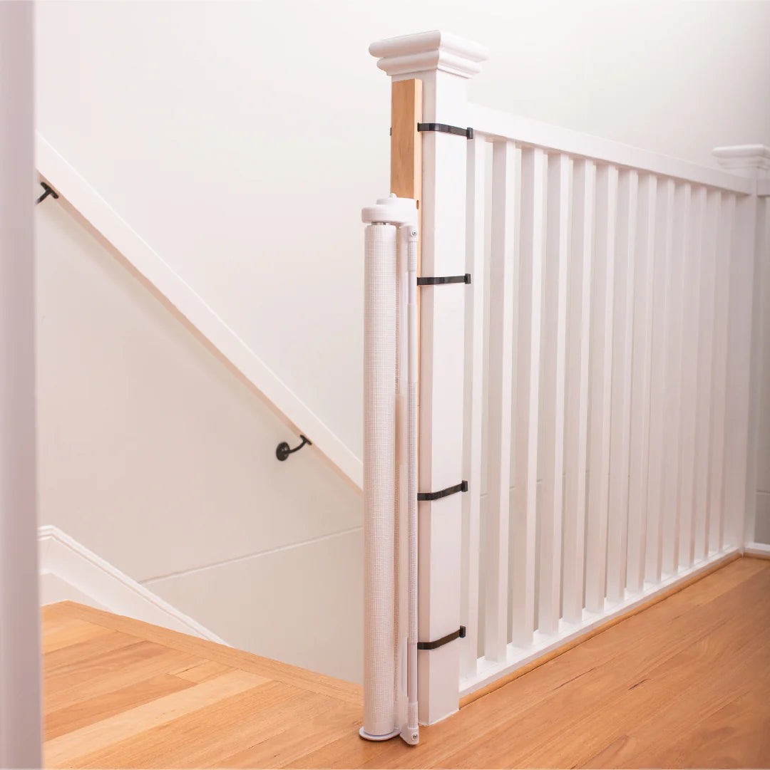 Staircase with white balusters and wooden handrails in a home setting.
