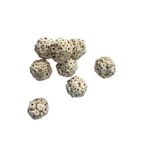 Seven small round carved beads with a textured, cross-hatched pattern in natural bone or ivory tones, scattered on a plain white background at Pet Servo