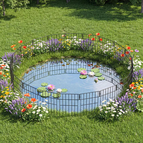 Small pond with decorative metal fence surrounded by flowers in a garden at Pet Servo