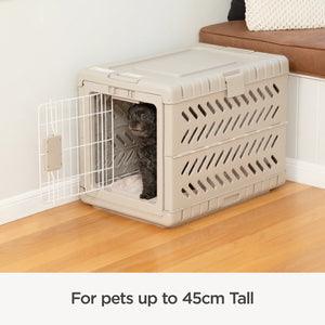 Pet crate with a cat inside on a wooden floor, next to a sofa.