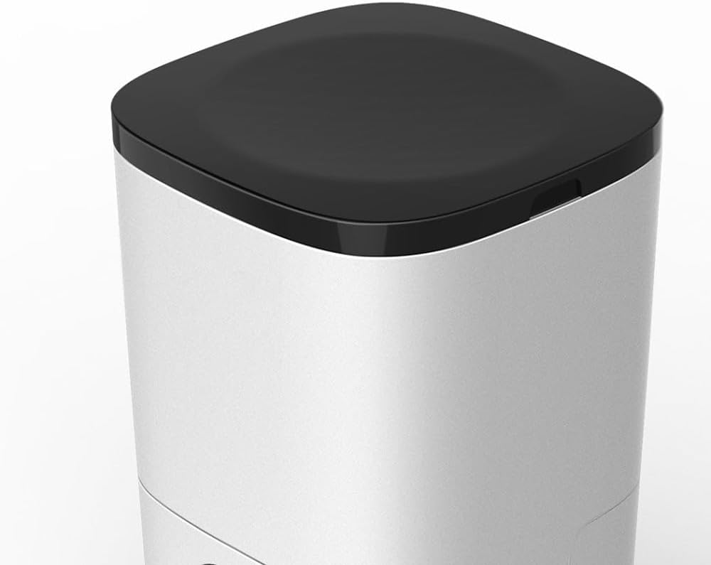 A close-up of a modern cylindrical appliance, likely a humidifier or air purifier, featuring a brushed silver body and a black top lid, shown against a plain white background at Pet Servo
