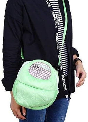 Person holding a green textured ball-like object with a black jacket and jeans at Pet Servo