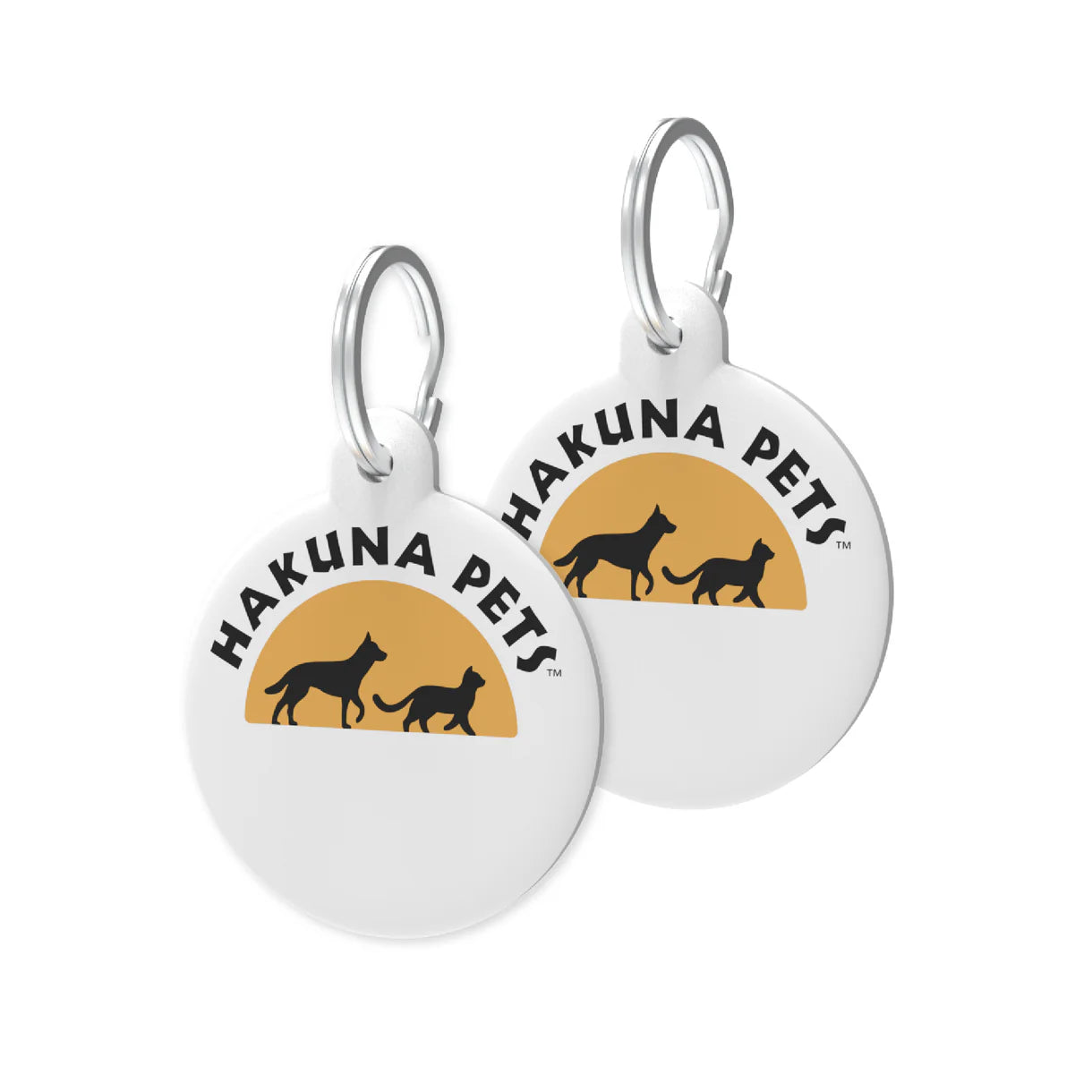 Two round white pet tags with 'Hakuna Pets' logo featuring silhouettes of dogs against a sunset background.