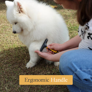 Person grooming a white dog with a grooming tool on grass, emphasizing the ergonomic handle.