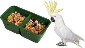 Green bird feeder with two compartments of seeds and a white parrot with a yellow crest on a white background at Pet Servo