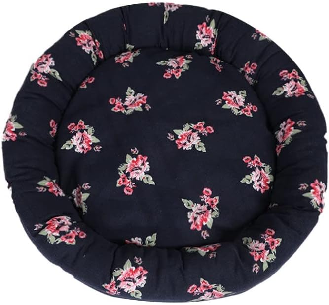 A round, plush pet bed with a dark navy blue background and a scattered pink and green floral print, shown against a plain white background at Pet Servo
