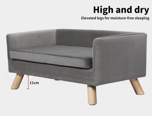 Gray pet bed with elevated wooden legs on a white background at Pet Servo