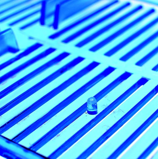 Close-up of a blue grid with a small droplet on it at Pet Servo