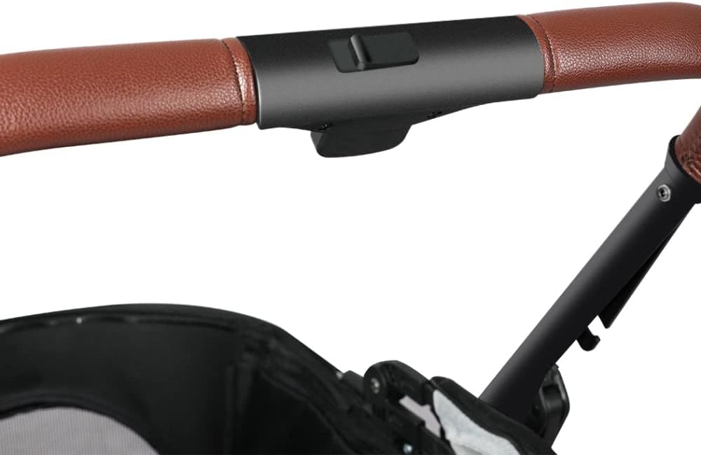 Close-up of a stroller handlebar with brown faux-leather grips, a black central control cover, and part of the stroller canopy and frame visible against a white background at Pet Servo