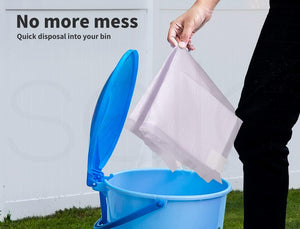 A person holds a translucent white disposal bag above an open blue bucket, with the text 'No more mess Quick disposal into your bin' on a white wall at Pet Servo