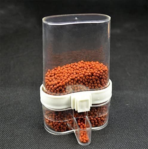 Fishing bait dispenser with red pellets on a dark background at Pet Servo