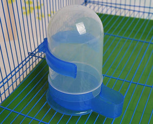 Blue and clear plastic water bottle on a green wire cage at Pet Servo