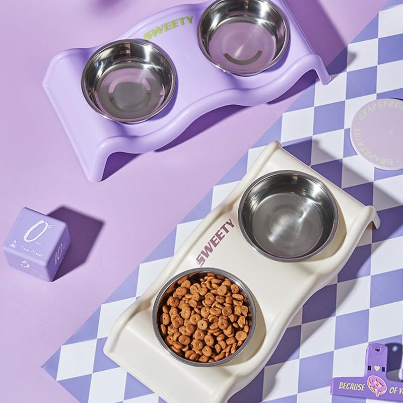 Two pet feeding stations arranged on a lavender and white checkered surface. The top station is lavender with stainless steel bowls, and the bottom station is cream with one bowl filled with kibble at Pet Servo