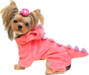 Small dog wearing a pink dinosaur costume on a white background at Pet Servo