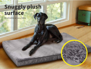 Dog lying on a gray plush dog bed with a close-up of the fabric texture at Pet Servo