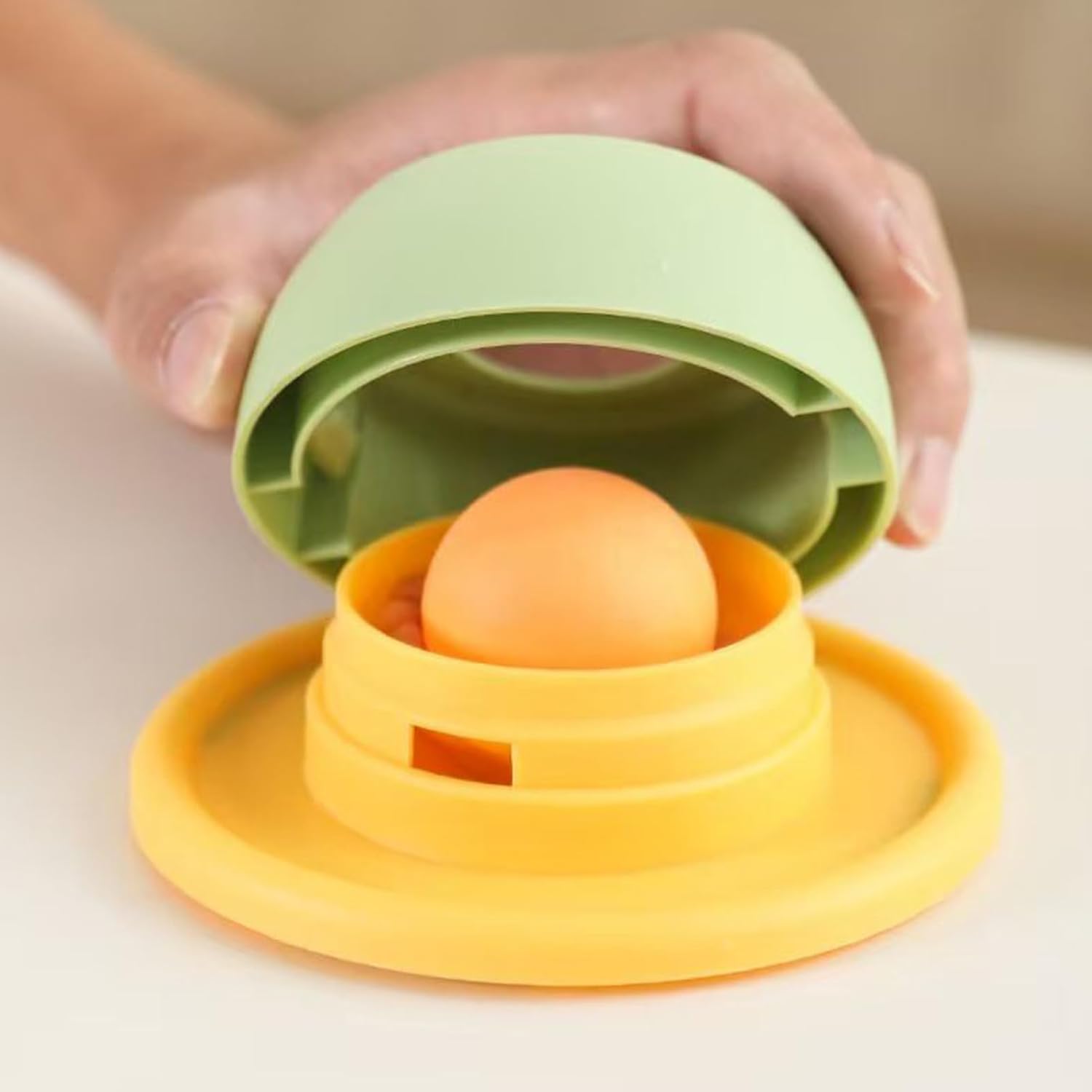 Stackable silicone egg holder with a hand lifting one of the stacked holders to reveal an egg at Pet Servo