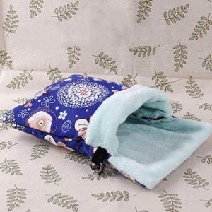 Folded fabric with blue and white pattern on a leaf-patterned background at Pet Servo