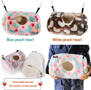 Collage of plush pet houses with heart patterns, labeled 'Blue peach heart' and 'White peach heart', held by a person at Pet Servo