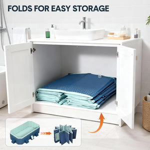 Blue foldable storage bags shown inside an open white bathroom vanity cabinet, with text reading 'FOLDS FOR EASY STORAGE' and a small inset showing the bag transforming into a bathtub.