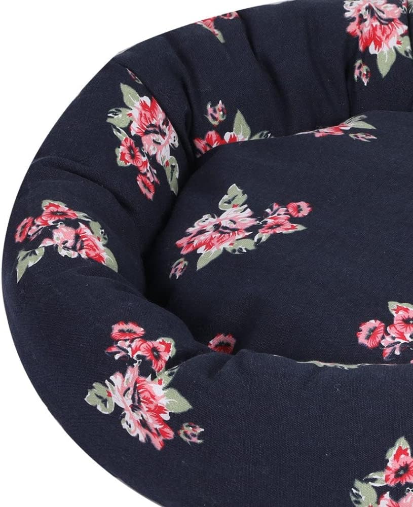 Close-up of a round pet bed or cushion with a dark navy-blue fabric and a red and pink floral print with green leaves, shown against a white background at Pet Servo