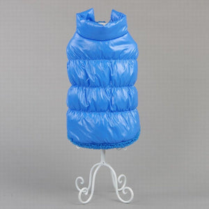 Blue puffer vest on a white stand against a gray background at Pet Servo