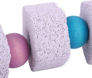 Close-up of textured sponges and beads on a white background at Pet Servo