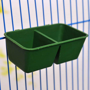 Green bird feeder attached to a blue cage at Pet Servo