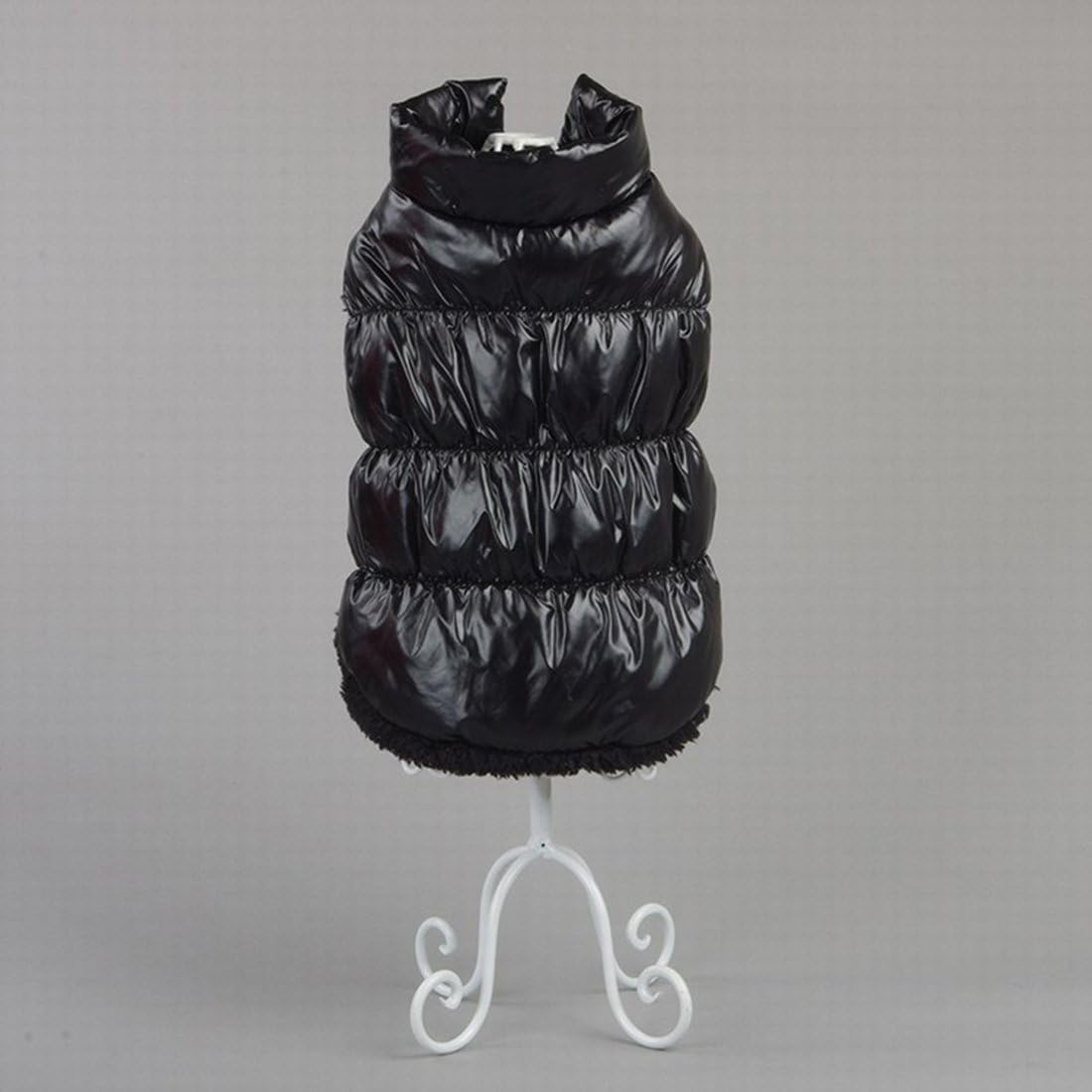 Black puffer vest on a white stand against a gray background at Pet Servo
