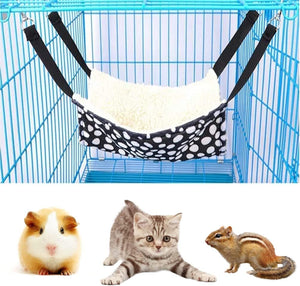 Pet hammock with black and white polka dots hanging inside a blue cage, with three pets below at Pet Servo