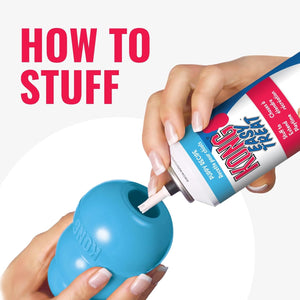 Person using KONG product to stuff a blue KONG toy with KONG stuffing at Pet Servo