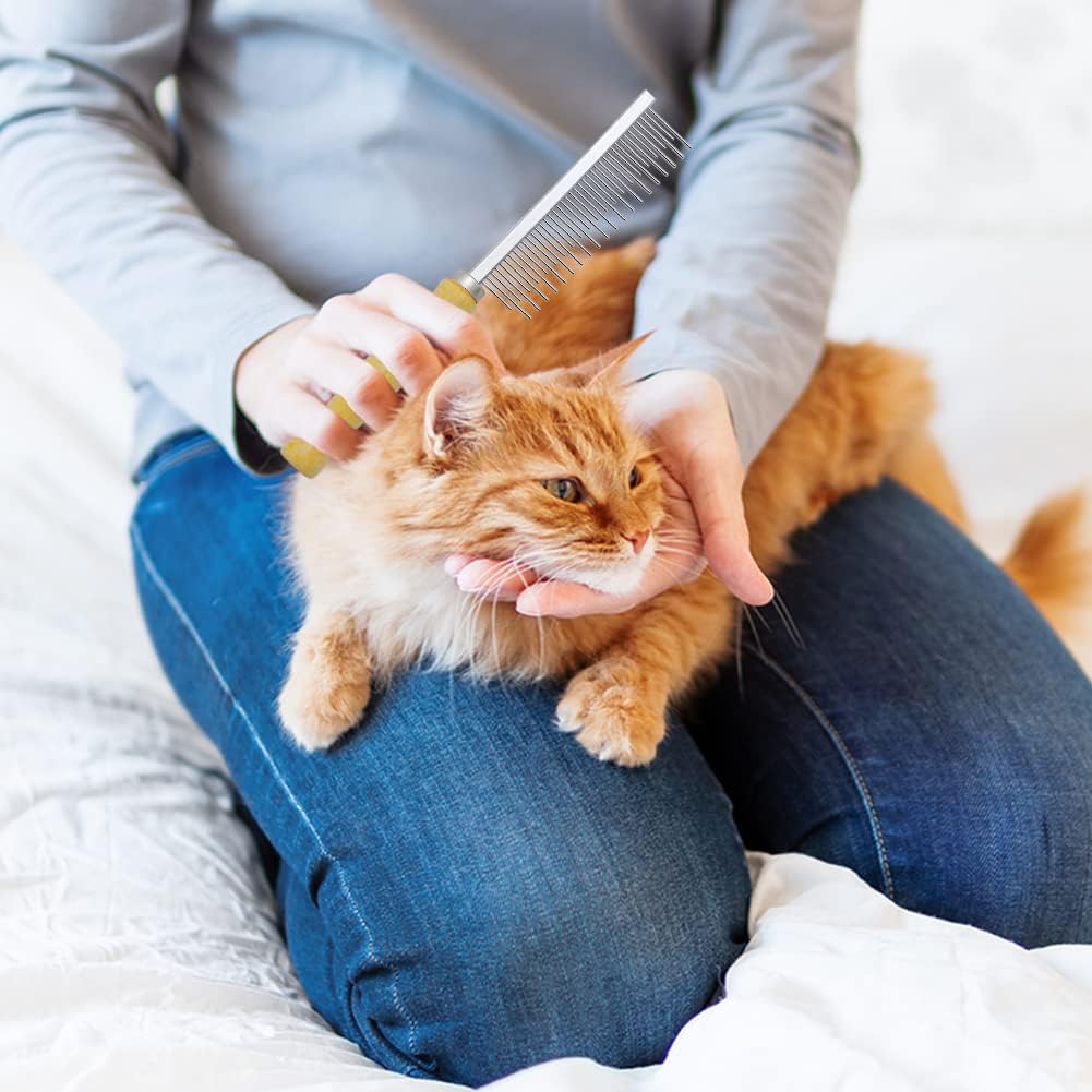 Person grooming a cat with a comb on a white surface at Pet Servo