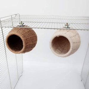 Two woven cat beds hanging from a metal rack against a white background at Pet Servo