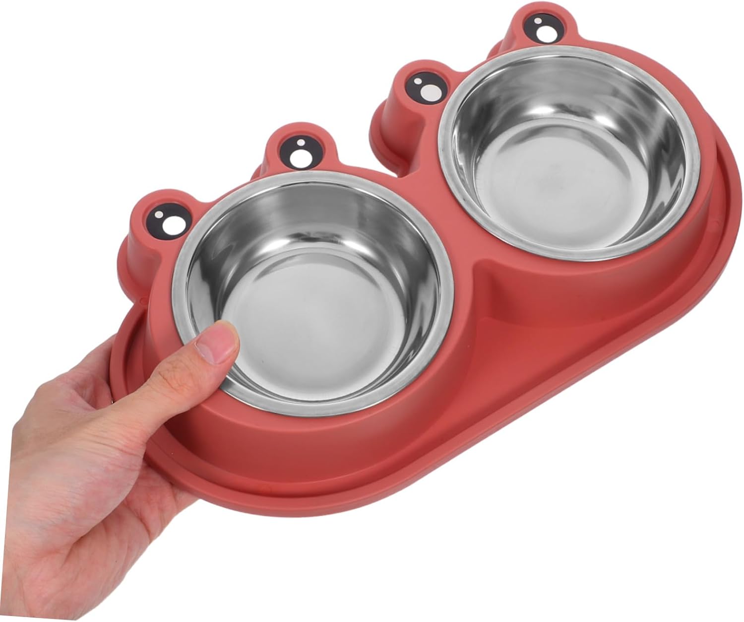 A red silicone pet feeding tray with two stainless steel bowls, held by a human hand against a plain white background at Pet Servo