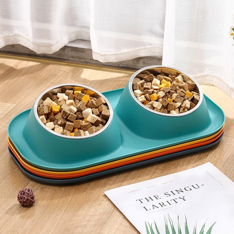 A two-bowl pet feeder and waterer tray set in teal, with stacked orange, yellow, and dark gray rims, shown on a wooden surface with food in the bowls and a curtain in the background at Pet Servo