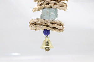 Decorative hanging item with rope, stone, blue bead, and gold bell on a white background at Pet Servo