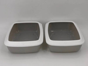 Two gray pet litter boxes with white lids on a gray background at Pet Servo