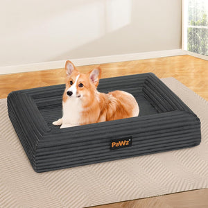 Dog lying on a large gray dog bed with 'PaWz' branding in a room with wooden flooring at Pet Servo