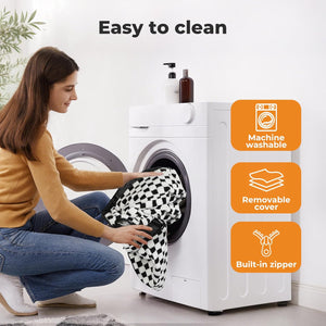 Woman loading a black and white patterned garment into a washing machine with cleaning features highlighted at Pet Servo
