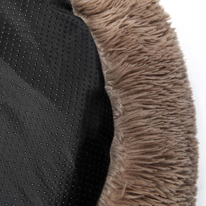 Close-up of black textured fabric and brown fluffy material on a white background at Pet Servo
