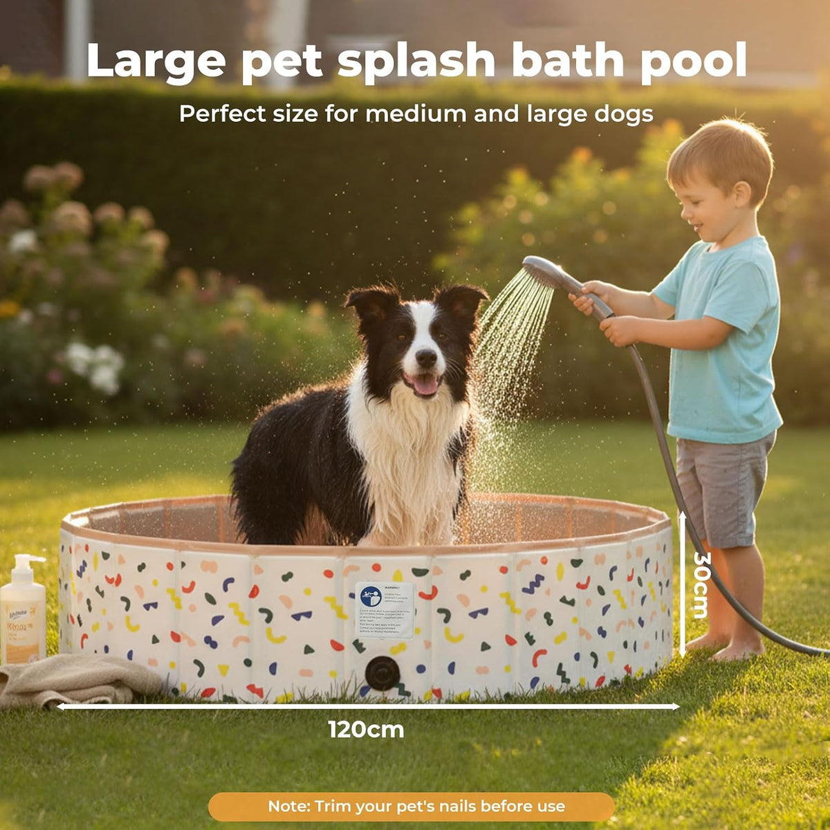 A child watering a black and white dog in a large outdoor splash bath pool on a grassy lawn. Text at the top reads 'Large pet splash bath pool' and 'Perfect size for medium and large dogs,' with dimension labels showing 120cm width and 300mm depth.