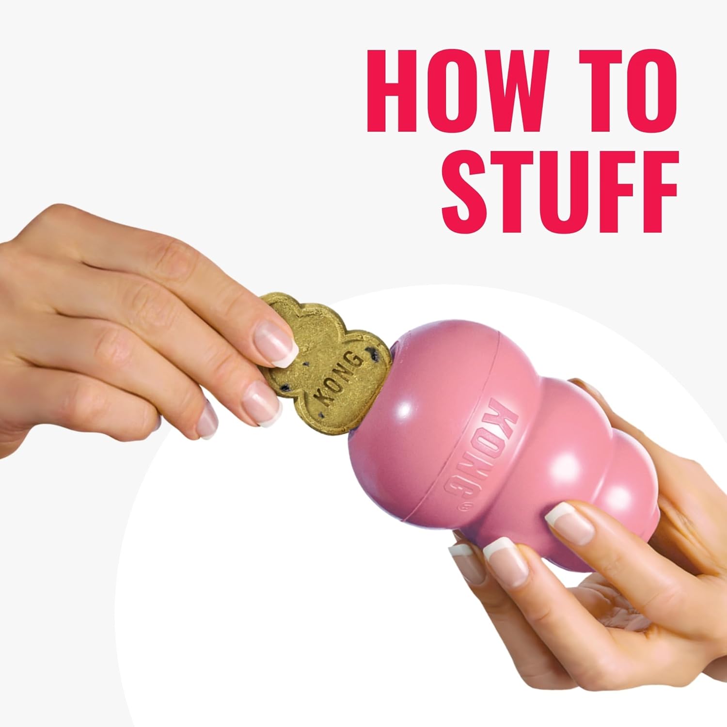 Pink KONG dog toy with a hand holding a treat, on a white background with 'How to Stuff' text at Pet Servo