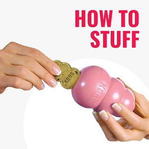 Pink KONG dog toy with a hand holding a treat, on a white background with 'How to Stuff' text at Pet Servo
