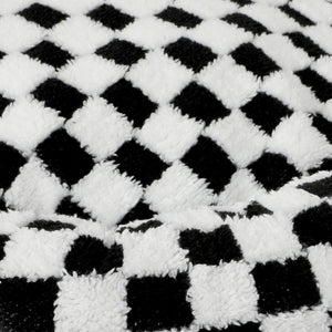 Close-up of a black and white checkered pattern fabric at Pet Servo