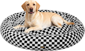 Dog lying on a checkered pet bed with a visible brand logo at Pet Servo