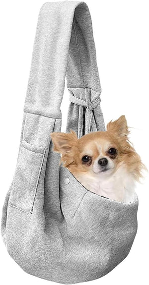 Small dog in a gray pet sling against a white background at Pet Servo
