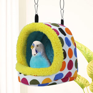 Colorful polka dot pet bed with a parakeet inside, hanging against a white background at Pet Servo