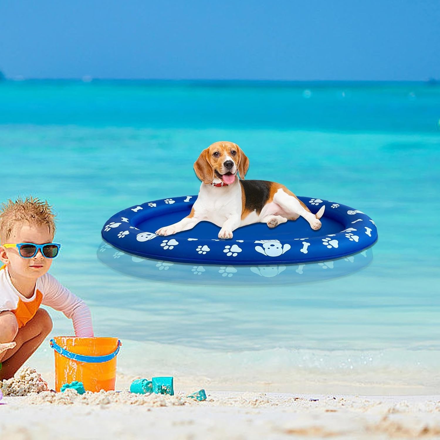 Dog on a blue inflatable pool toy in the ocean with a child nearby at Pet Servo