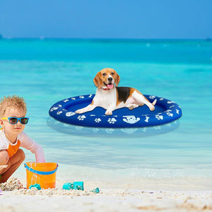 Dog on a blue inflatable pool toy in the ocean with a child nearby at Pet Servo